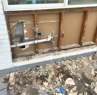 Wall opened to reach a burst water pipe in a Bedford, TX home